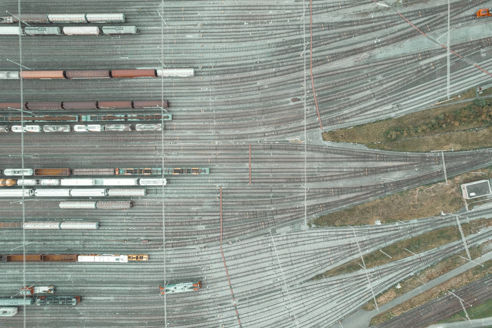 Parallel tracks and standing wagons seen straight down over a sorting yard